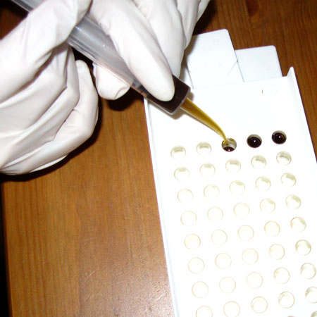 Dispensing oil into the capsules.